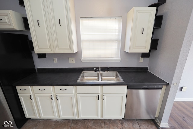 kitchen featuring appliances with stainless steel finishes, white cabinets, sink, and light hardwood / wood-style floors