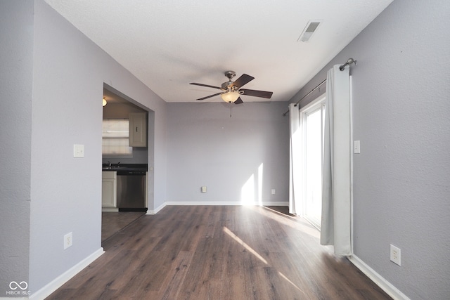 unfurnished living room with sink, ceiling fan, and dark hardwood / wood-style flooring