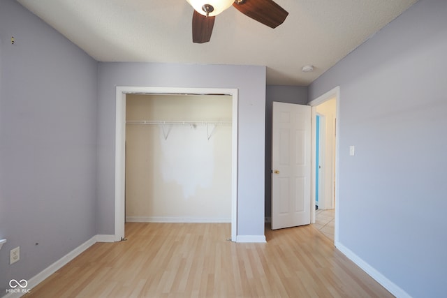 unfurnished bedroom featuring a closet, ceiling fan, a textured ceiling, and light hardwood / wood-style flooring