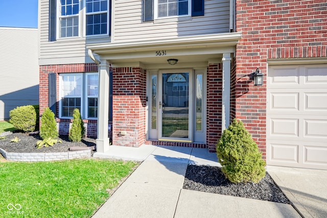 doorway to property with a garage