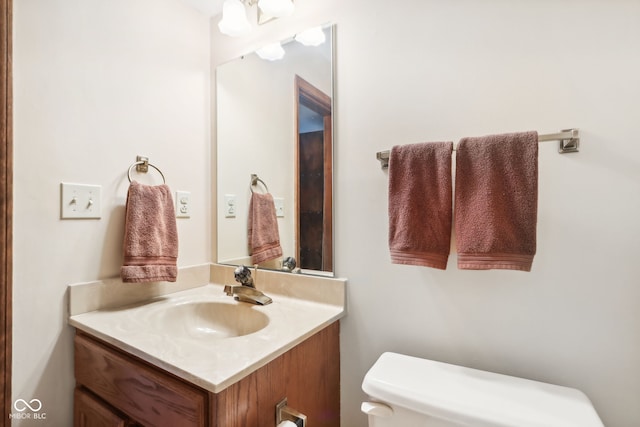 bathroom featuring toilet and vanity