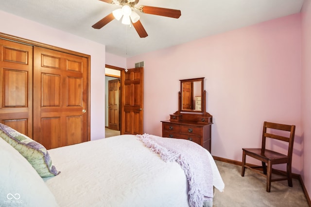 carpeted bedroom featuring a closet and ceiling fan