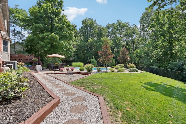 view of yard with a fenced in pool, a patio area, and central AC unit