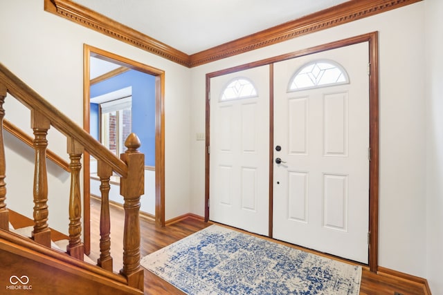 entryway with crown molding and dark hardwood / wood-style floors