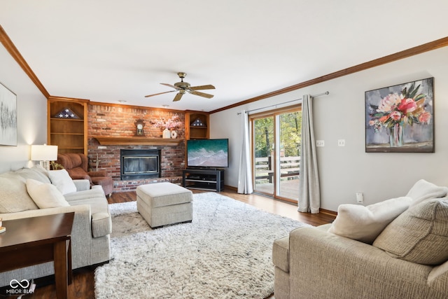 living room featuring ornamental molding, a brick fireplace, hardwood / wood-style flooring, and ceiling fan