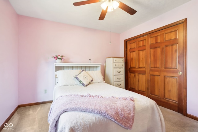 carpeted bedroom featuring a closet and ceiling fan