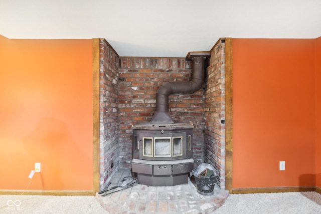 interior details with carpet flooring and a wood stove