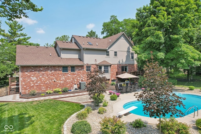 rear view of property featuring a yard and a patio area