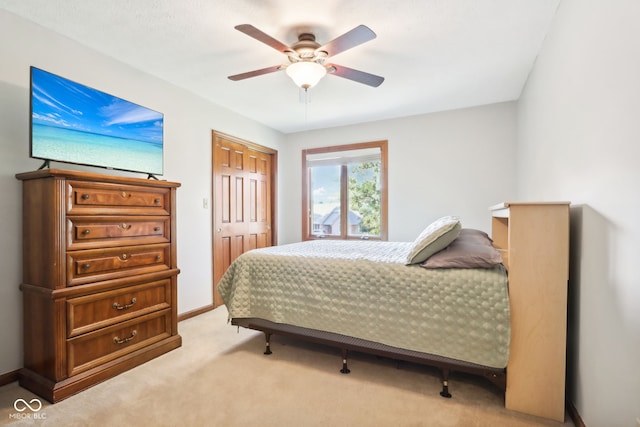 carpeted bedroom with a closet and ceiling fan