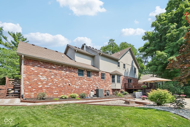 back of property with a patio, a lawn, and cooling unit