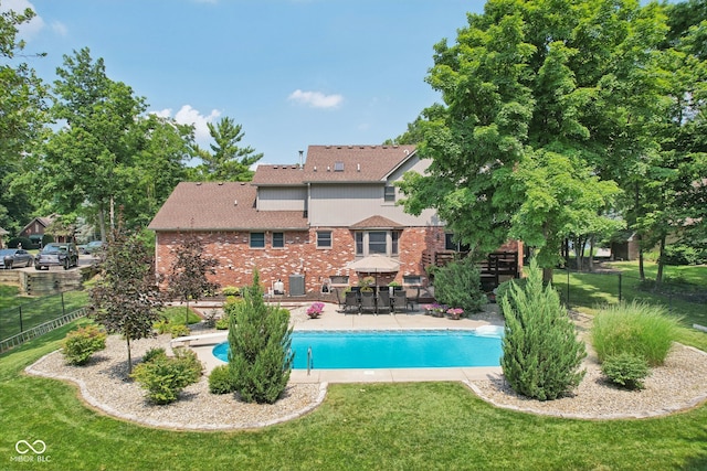 view of pool with a patio area and a yard