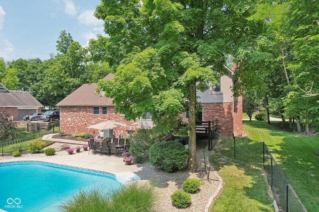 view of pool with a patio and a yard