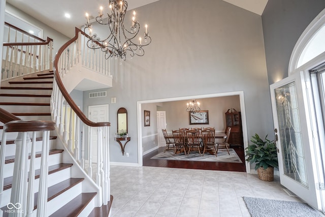 entrance foyer with a chandelier, light hardwood / wood-style flooring, and high vaulted ceiling