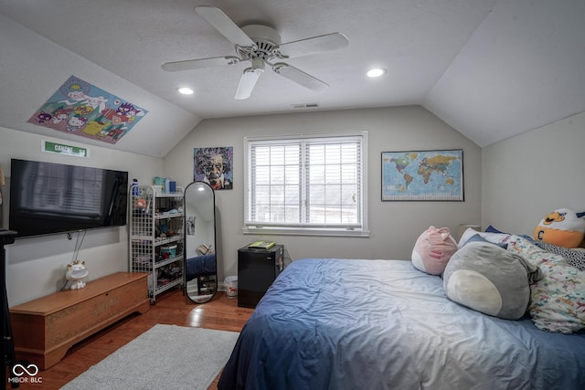 bedroom featuring a textured ceiling, ceiling fan, wood-type flooring, and vaulted ceiling