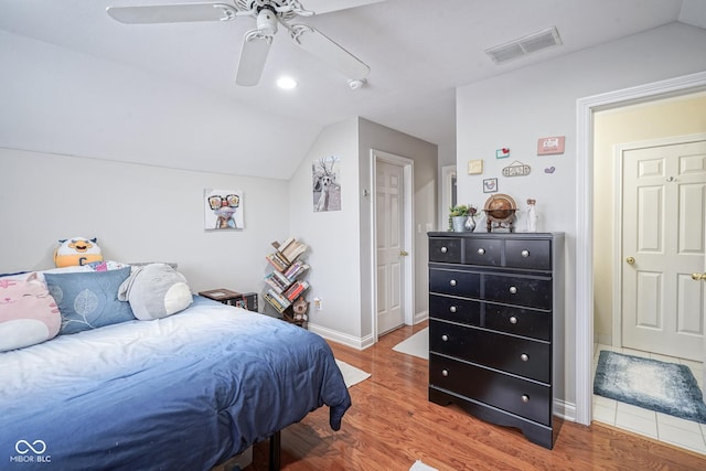 bedroom with hardwood / wood-style flooring, ceiling fan, and lofted ceiling