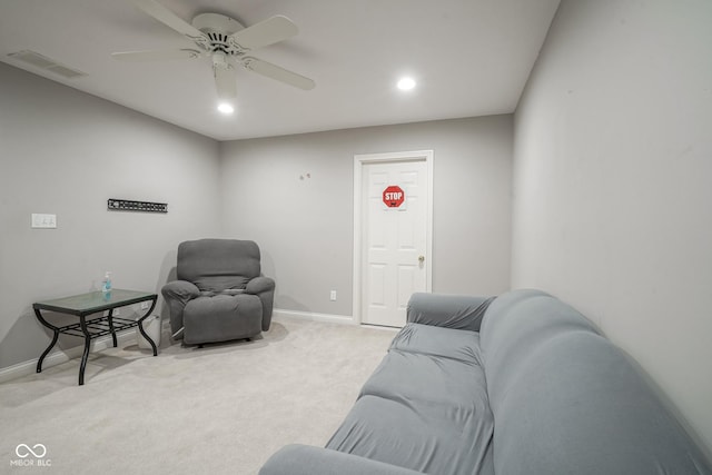 carpeted living room featuring ceiling fan