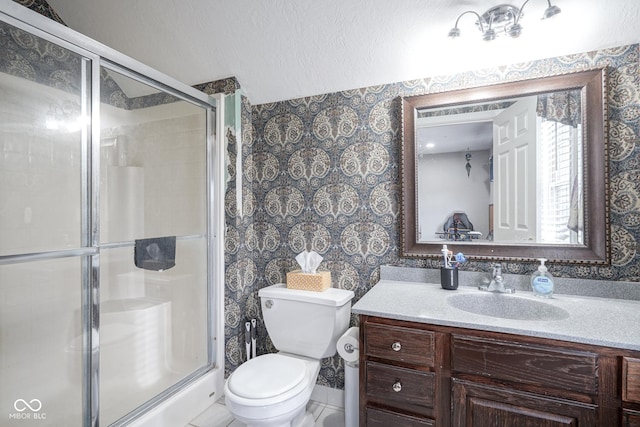 bathroom with tile patterned flooring, vanity, toilet, and a shower with door