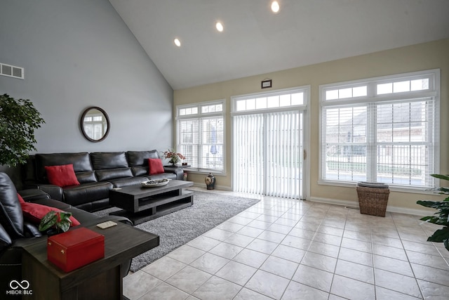 tiled living room with high vaulted ceiling