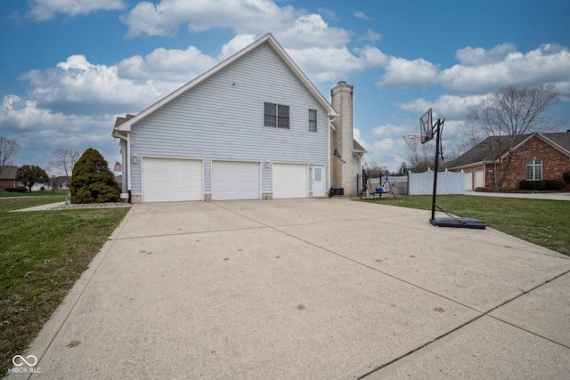 view of property exterior featuring a yard and a garage