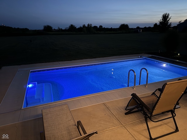 view of pool at dusk