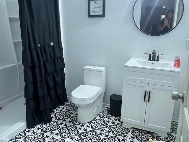 bathroom featuring vanity, curtained shower, toilet, and tile patterned floors