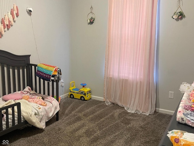 bedroom featuring a crib and carpet flooring