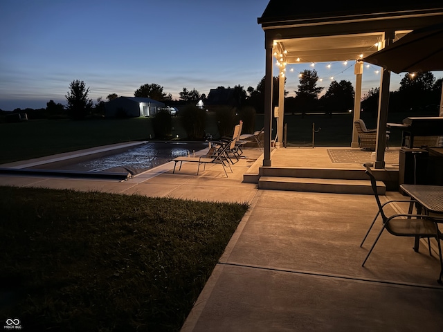 view of patio terrace at dusk