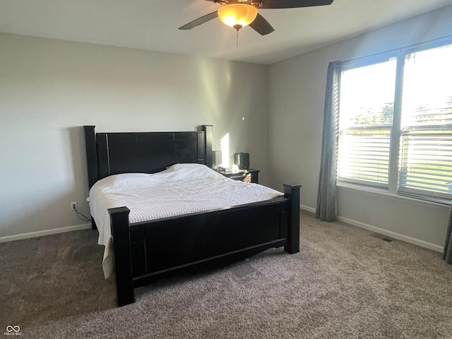 carpeted bedroom with multiple windows and ceiling fan