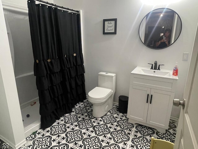 bathroom featuring vanity, toilet, tile patterned floors, and a shower with curtain