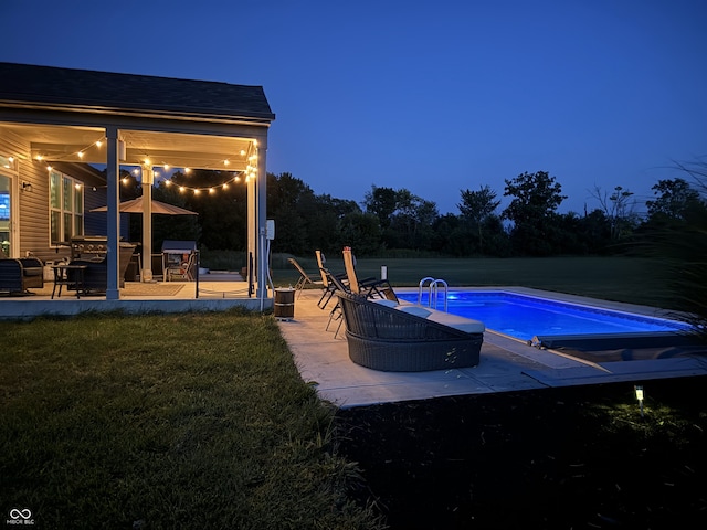 view of pool with a yard and a patio area