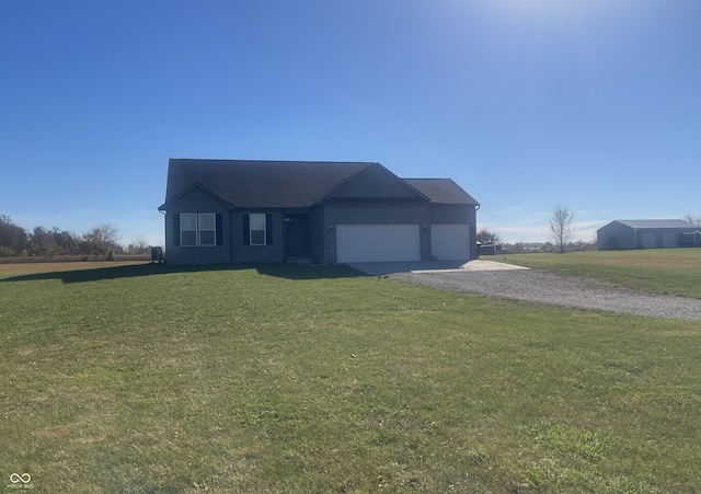 view of front of property featuring a front yard and a garage