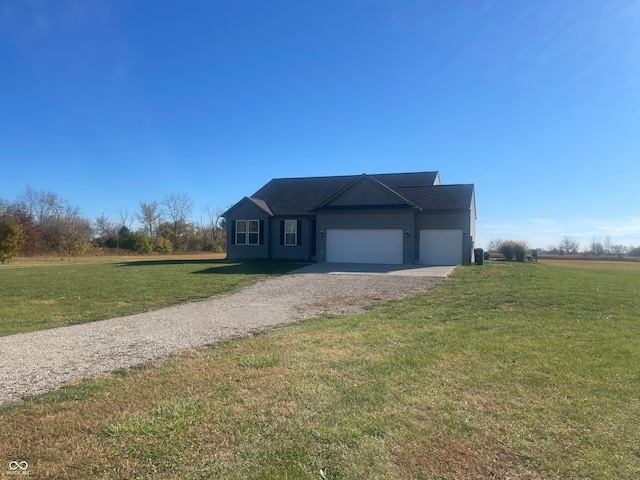 view of front of property featuring a front yard and a garage