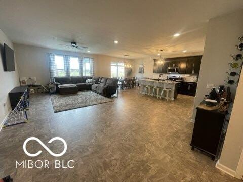 living room featuring recessed lighting and a ceiling fan
