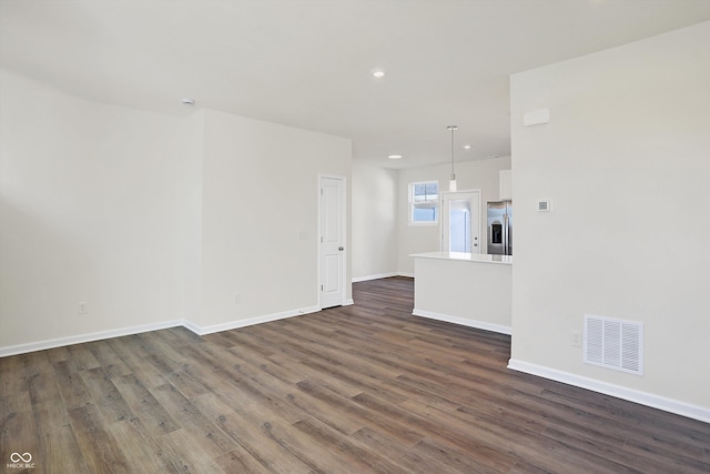 unfurnished living room with dark hardwood / wood-style flooring