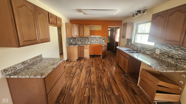 2620 Wicker Rd, Indianapolis, IN 46217 - kitchen with decorative backsplash, sink, dark wood-type flooring, and light stone counters
