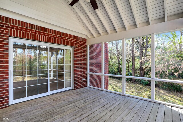 unfurnished sunroom with lofted ceiling with beams, wood ceiling, and a ceiling fan