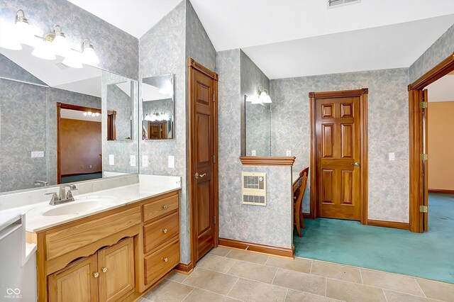 bathroom featuring lofted ceiling, visible vents, vanity, and wallpapered walls