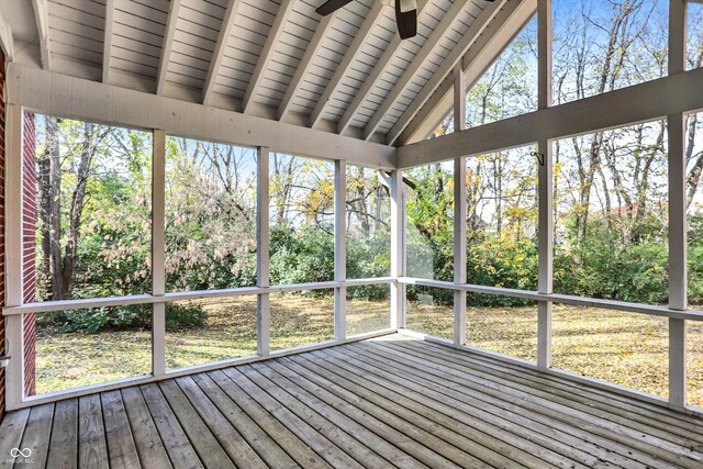 unfurnished sunroom featuring lofted ceiling with beams