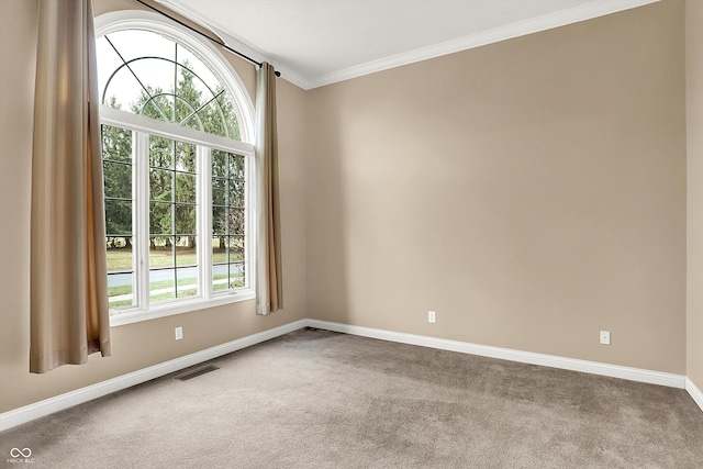 unfurnished room featuring ornamental molding, baseboards, visible vents, and carpet flooring