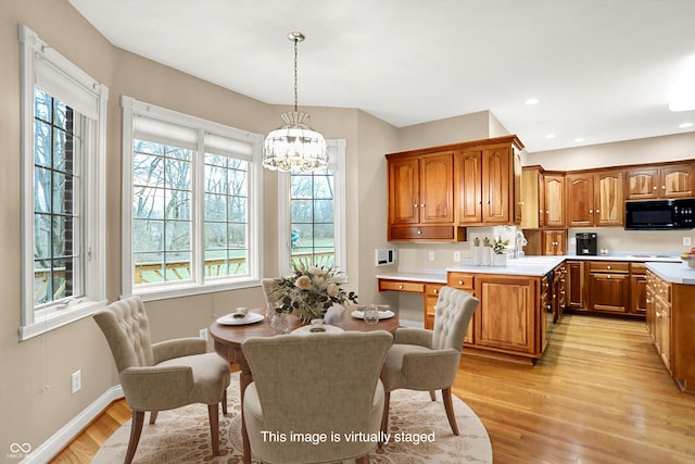 dining space with baseboards, recessed lighting, light wood-style flooring, and an inviting chandelier