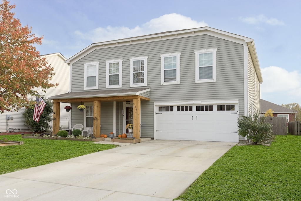 view of property featuring a front yard, a porch, and a garage