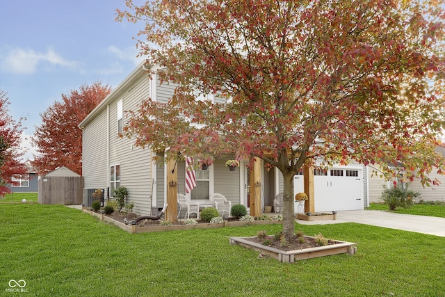 view of property hidden behind natural elements featuring a front yard, a storage unit, and a garage