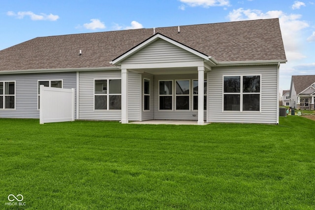 back of property featuring a lawn and a patio area