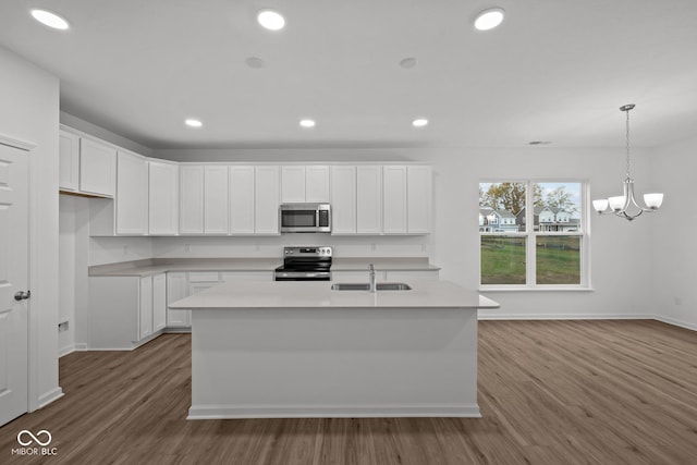 kitchen featuring wood-type flooring, white cabinetry, sink, and appliances with stainless steel finishes