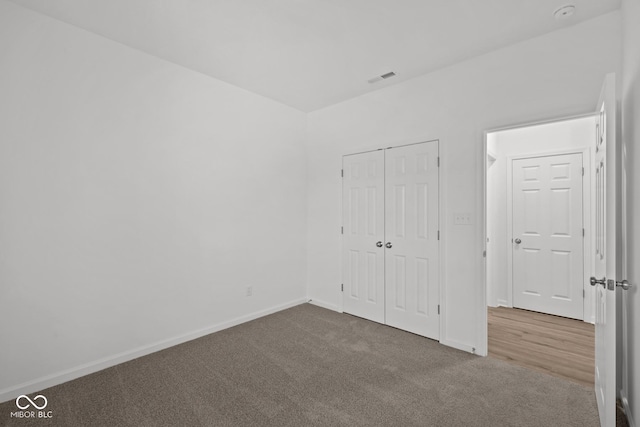 unfurnished bedroom featuring carpet floors and a closet