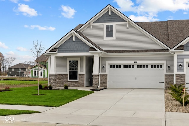 craftsman-style home featuring a garage and a front yard