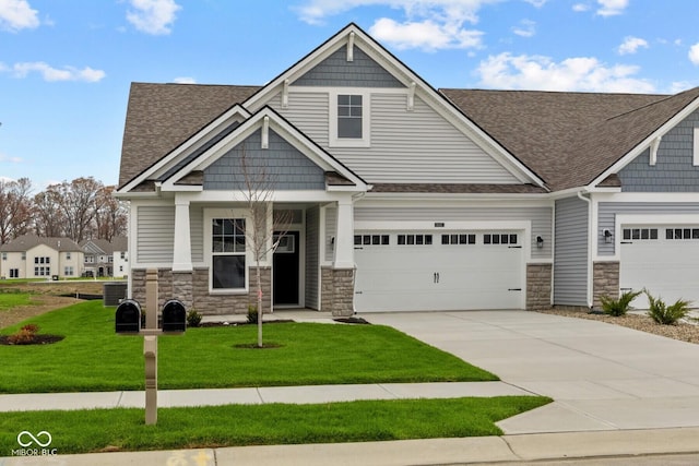 craftsman-style home featuring a front lawn and a garage