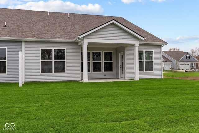 rear view of property with a lawn and a patio