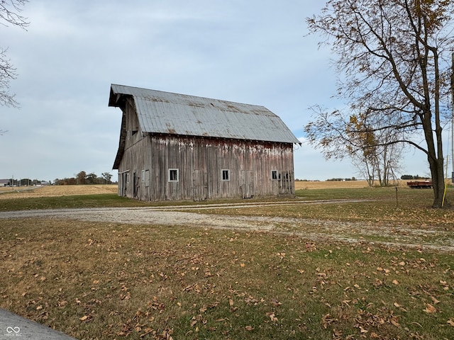 view of outdoor structure featuring a lawn