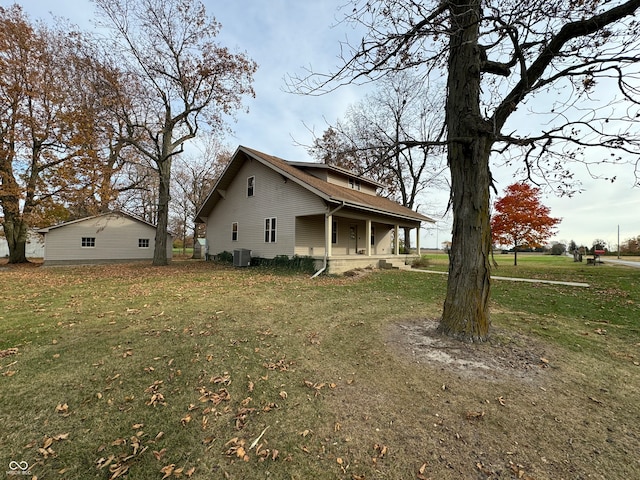 view of property exterior with central air condition unit and a lawn